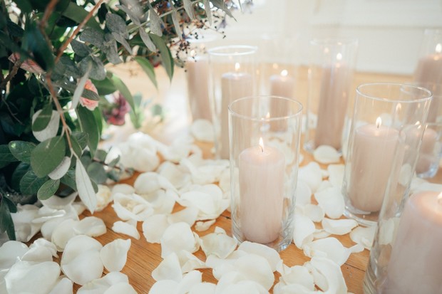 candles surrounded by rose petals