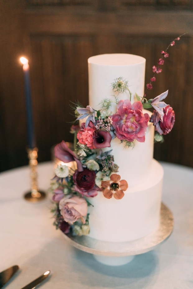 white wedding cake adorned with fresh florals