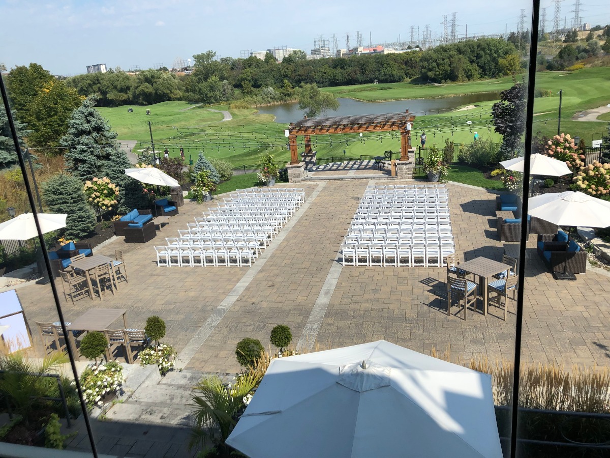 Outdoor wedding venue overlooking a golf course, ready for a ceremony