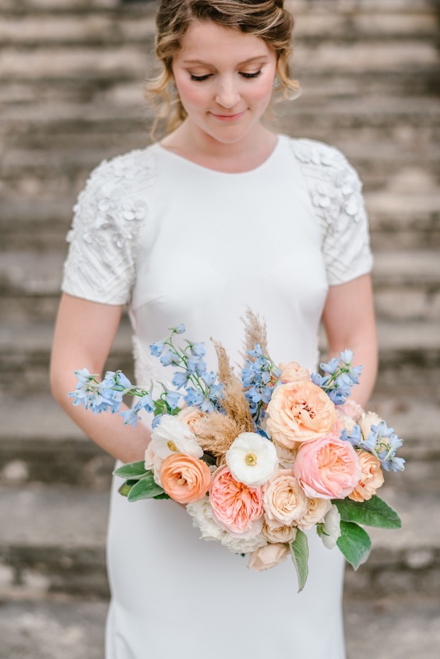 short and tight peachy pink and blue wedding bouquet