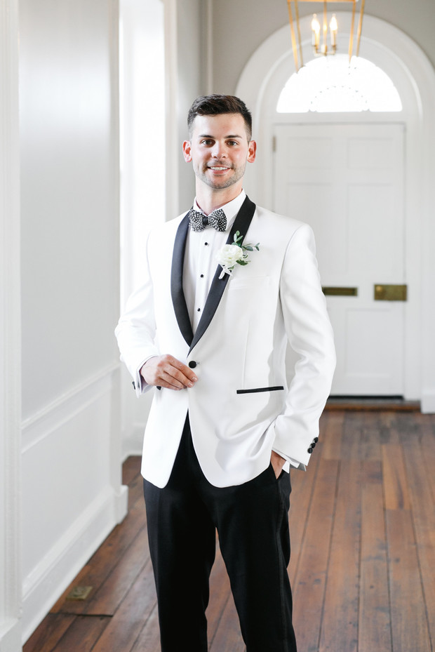 groom in white and black dinner jacket