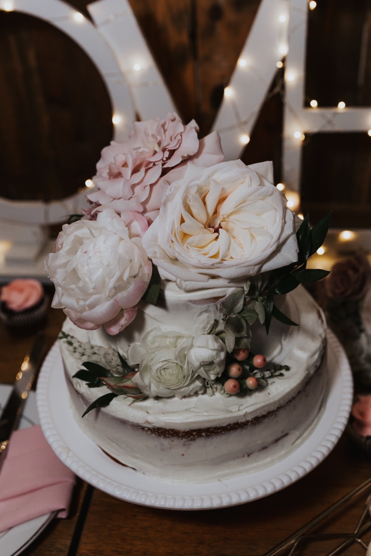 white wedding cake topped with florals