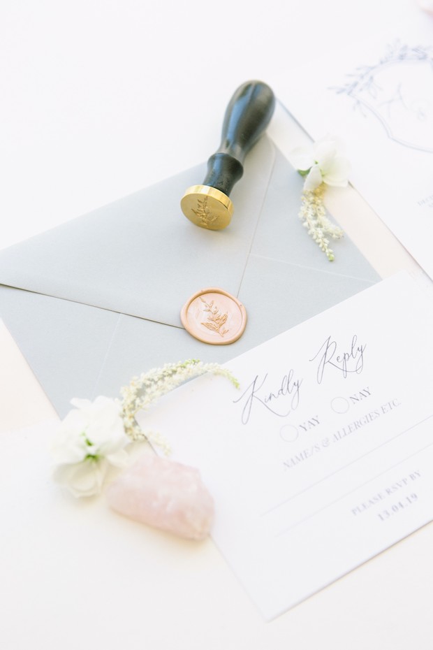 Elegant wedding invitation with wax seal and floral details