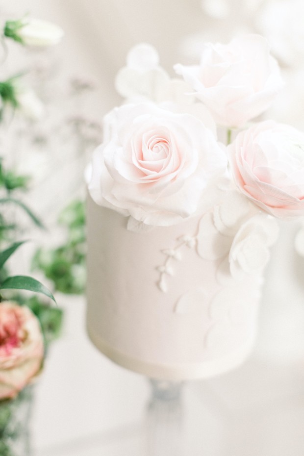 Elegant white cake with rose decorations for a wedding