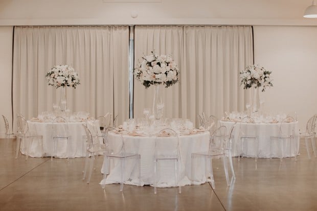 elegant wedding reception with ghost chairs