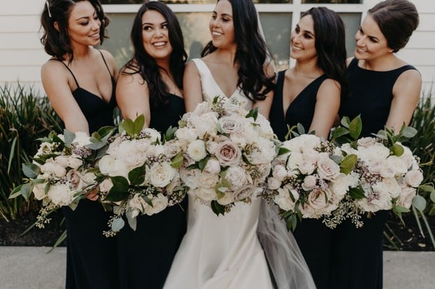 black bridesmaid dresses with peony and rose bouquets