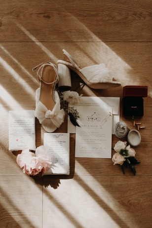 flat lay styling of invites and shoes