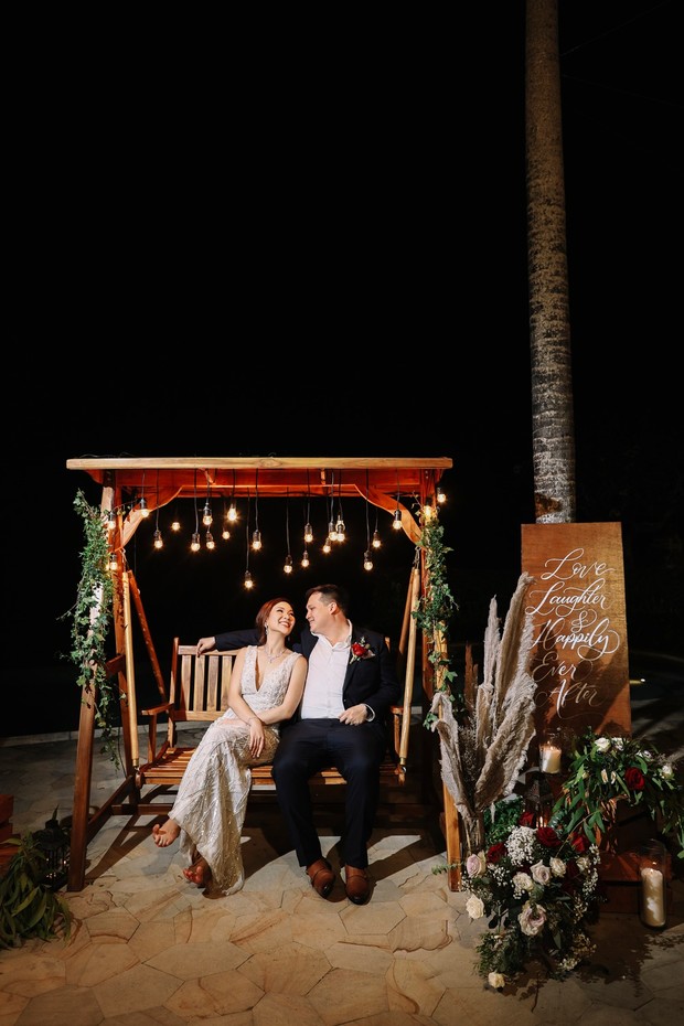 outdoor swing with vintage lights and florals