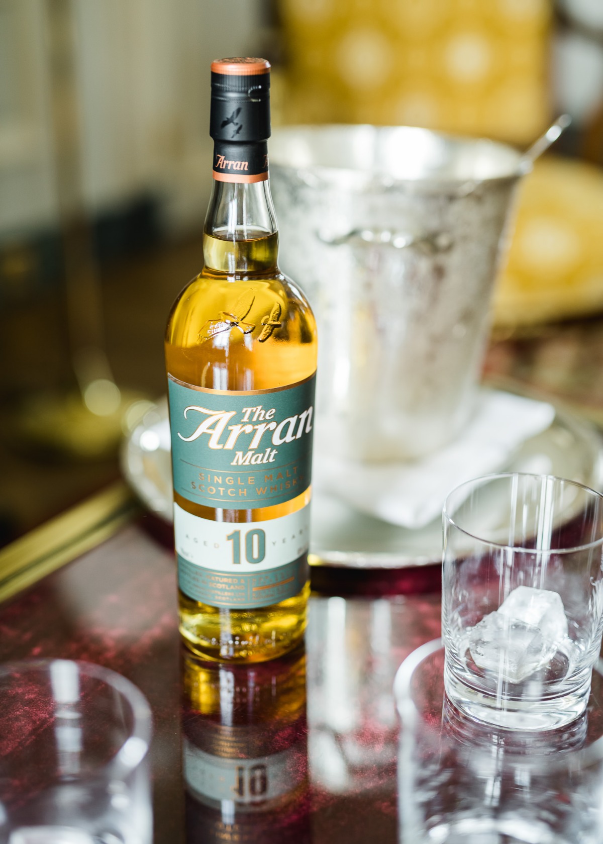 Arran Malt 10 year old whiskey bottle on a table with ice