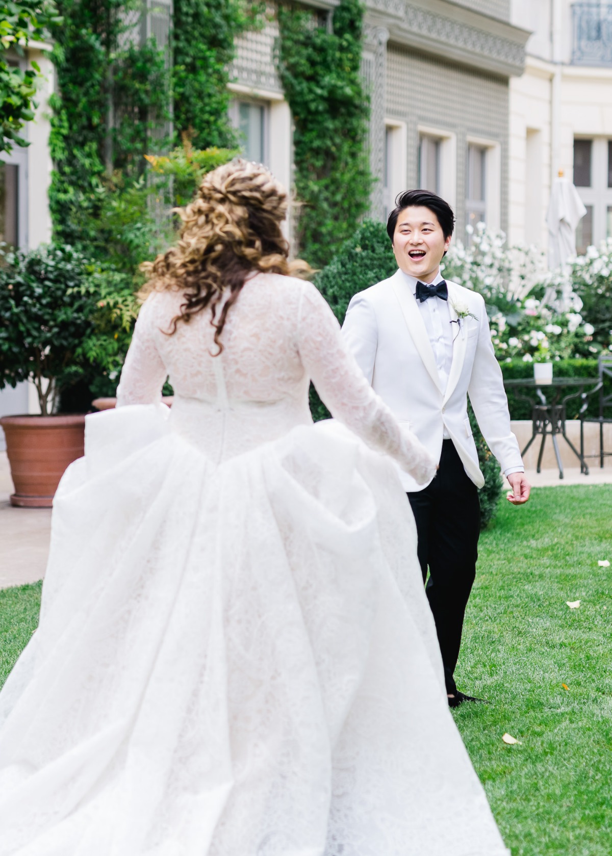 Bride walking towards groom on wedding day outside
