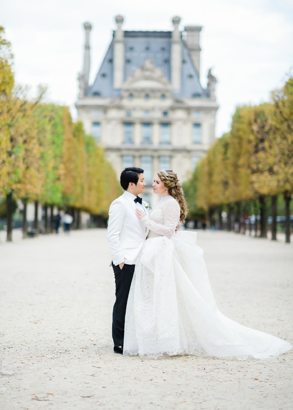 Elegant couple pose for a wedding photo in a grand setting