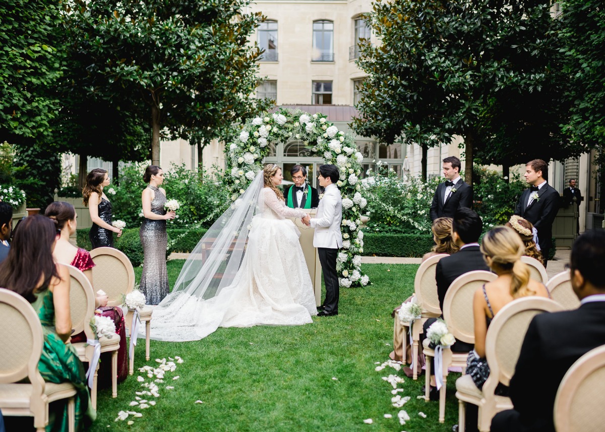 Elegant outdoor wedding ceremony with couple and guests gathered