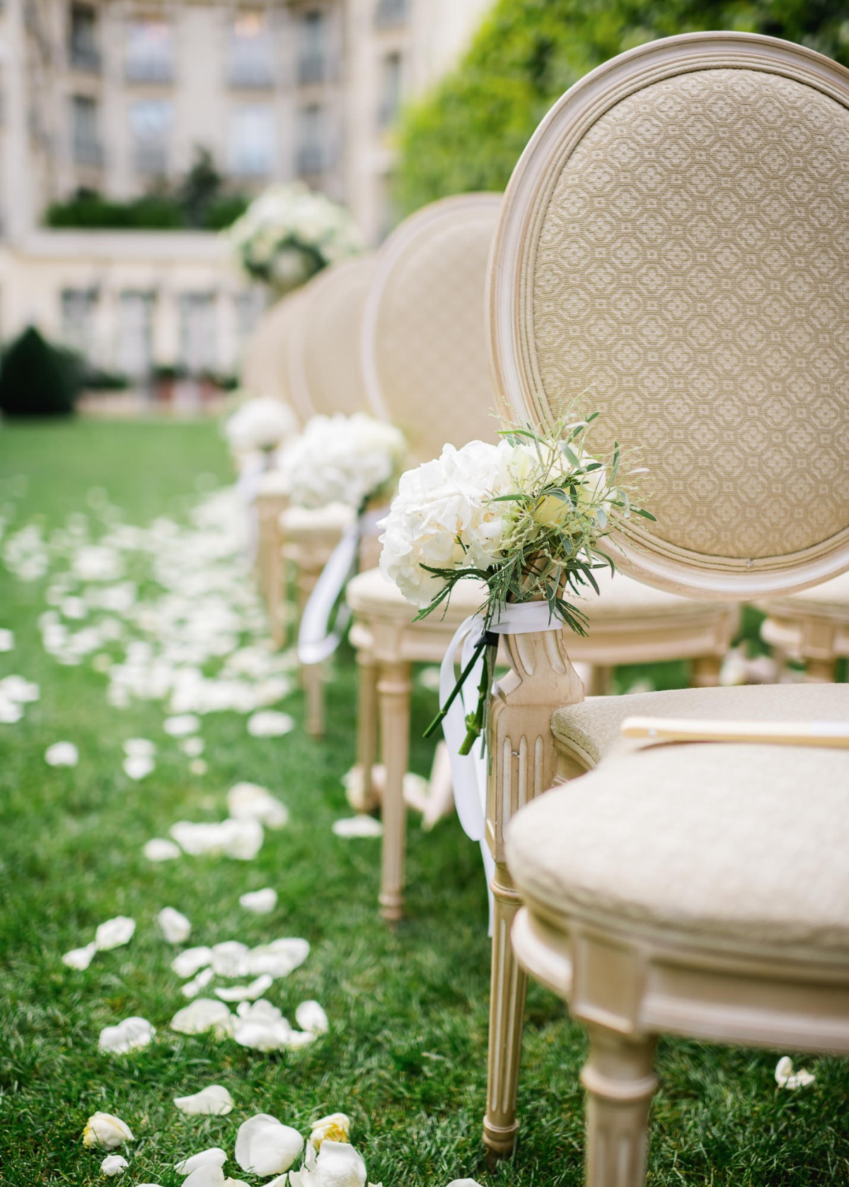Wedding ceremony chairs decorated with flowers on the grass, outdoor