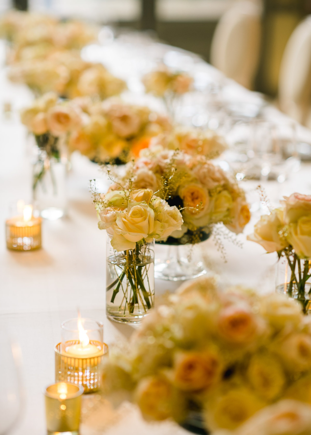 Elegant table setting with floral arrangements and candlelight