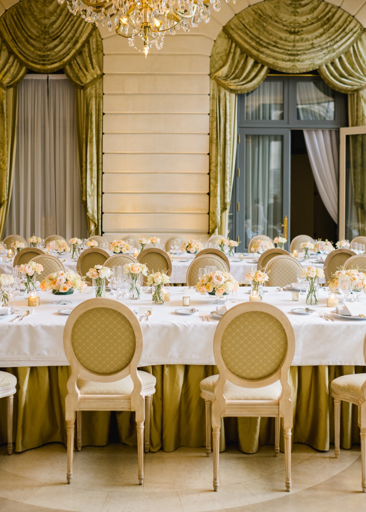 Elegant wedding reception setup with long table and flower centerpieces
