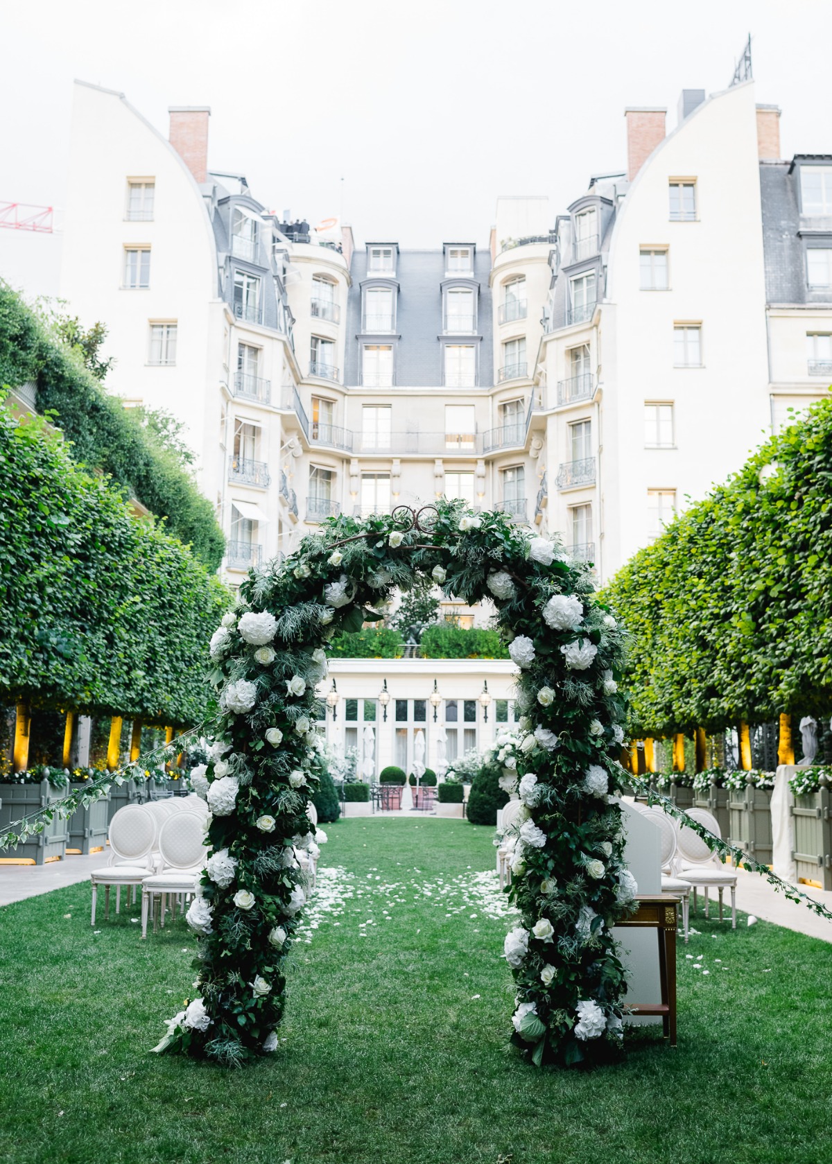 Elegant floral wedding archway in a beautiful courtyard setting