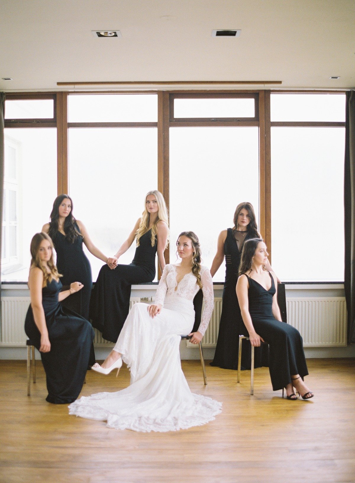 Bridesmaids in floor length black dresses