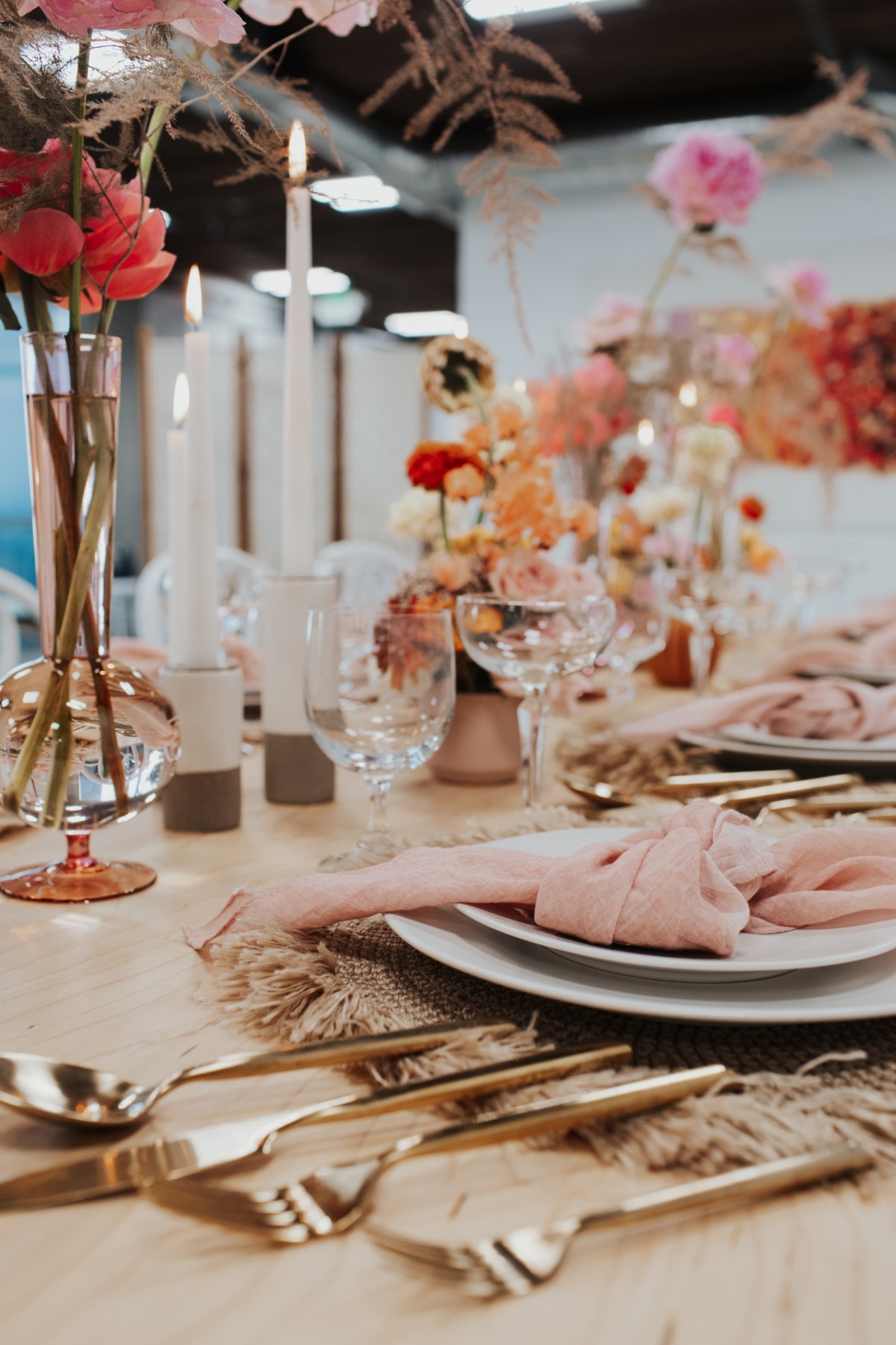 Elegant table setting with flowers and golden cutlery for event