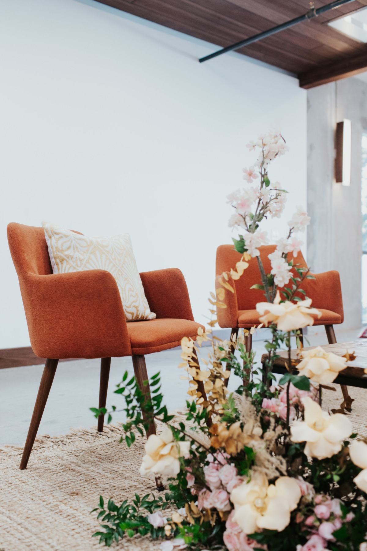 Stylish chairs and floral arrangement create a modern cozy interior