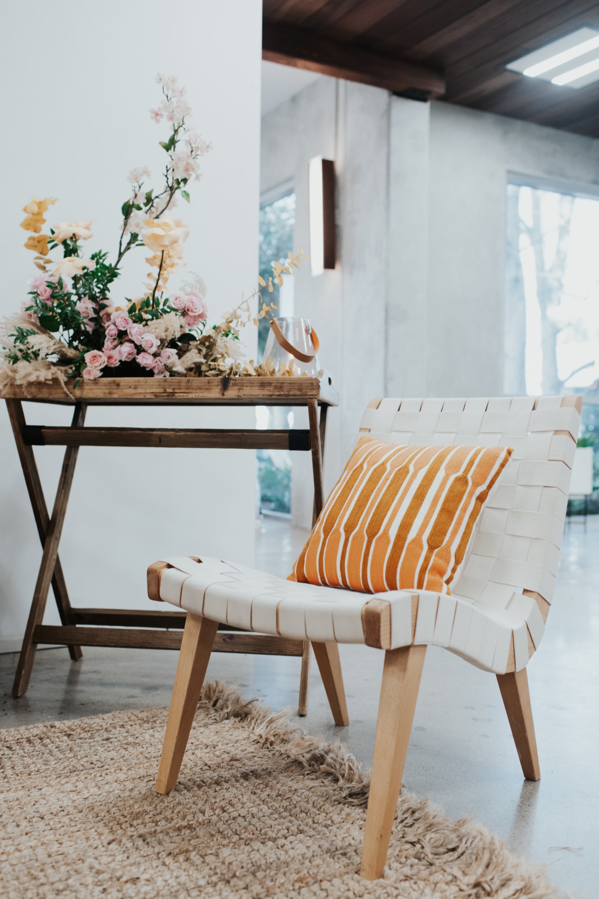 Cozy interior with modern chair and floral arrangement