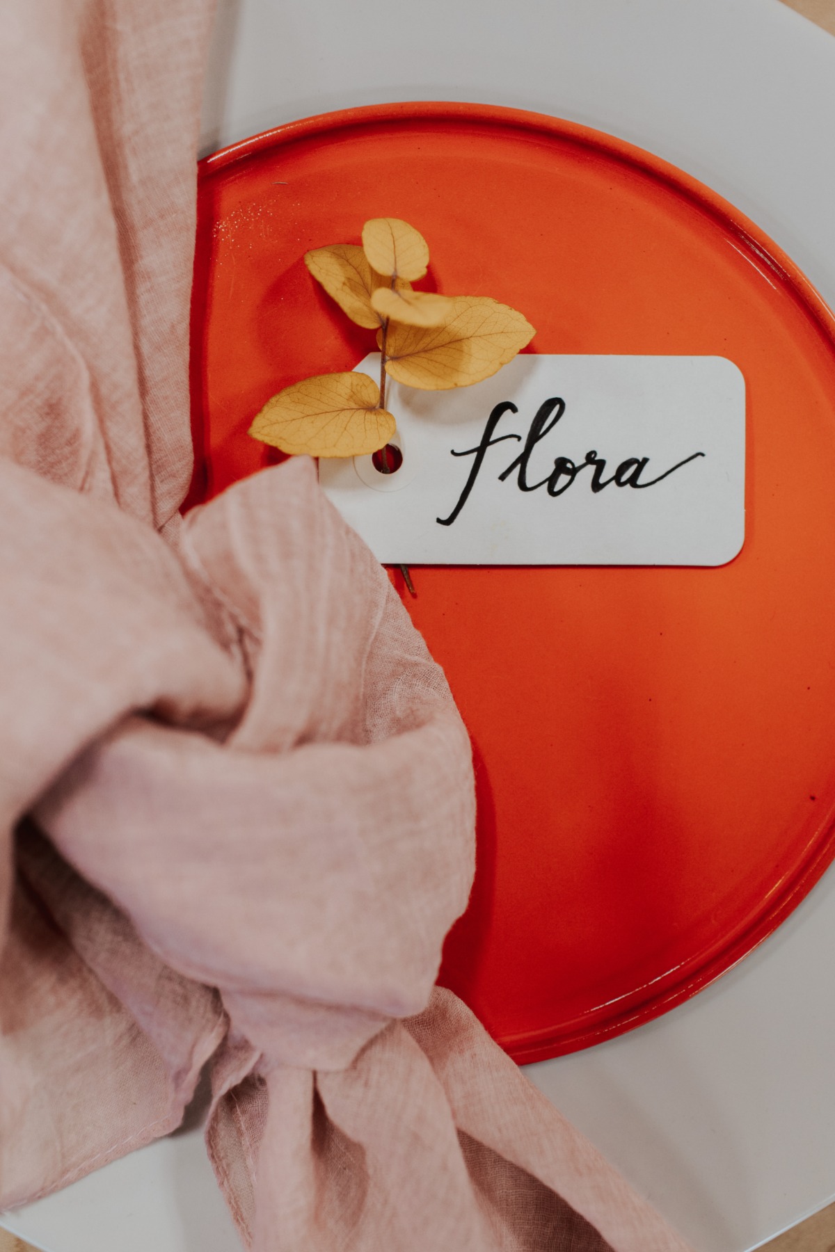 Elegant table setting with floral name tag and pink fabric