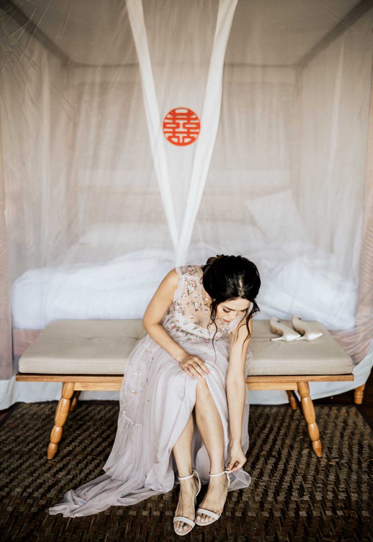 Bride adjusting her shoe before the wedding ceremony