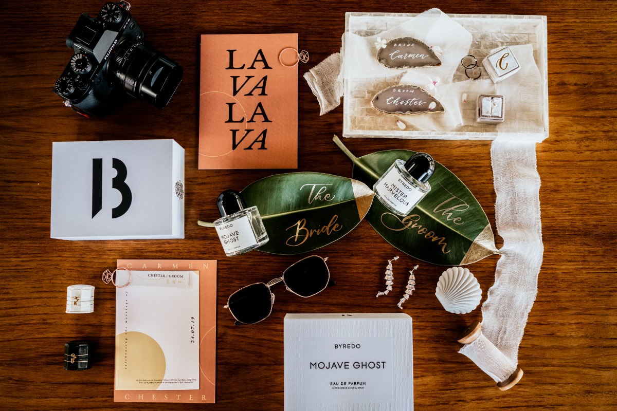 Wedding flat lay with perfume, invites, and accessories