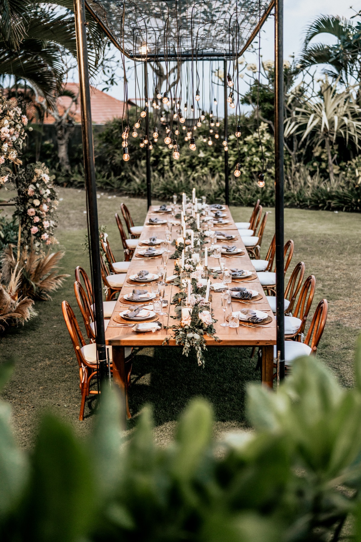 Elegant outdoor dining table setup under string lights