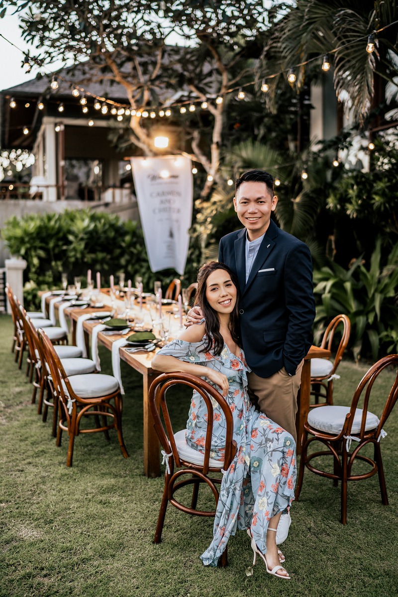 Couple smiling at camera during an outdoor celebration dinner