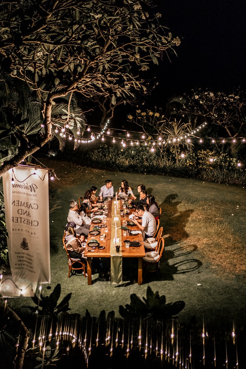 Outdoor dinner party with string lights, at night, Carmen and Chester