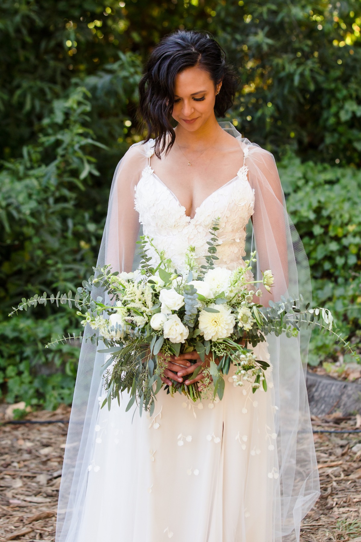 bride with white and green wedding bouquet