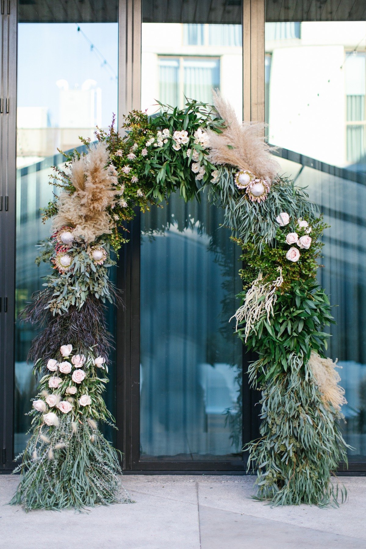Wedding arch decorated with eucalyptus, protea and paps grass