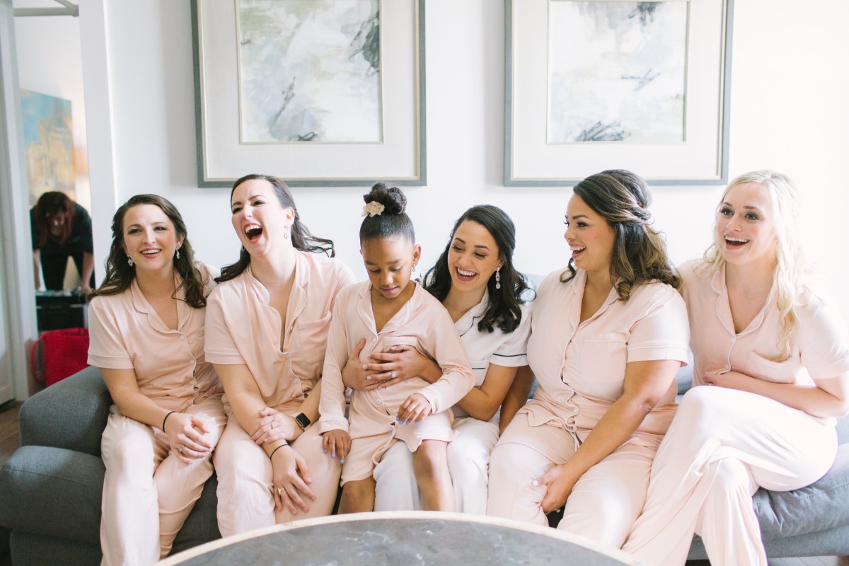 Bridesmaids laughing together in pajamas before the wedding day