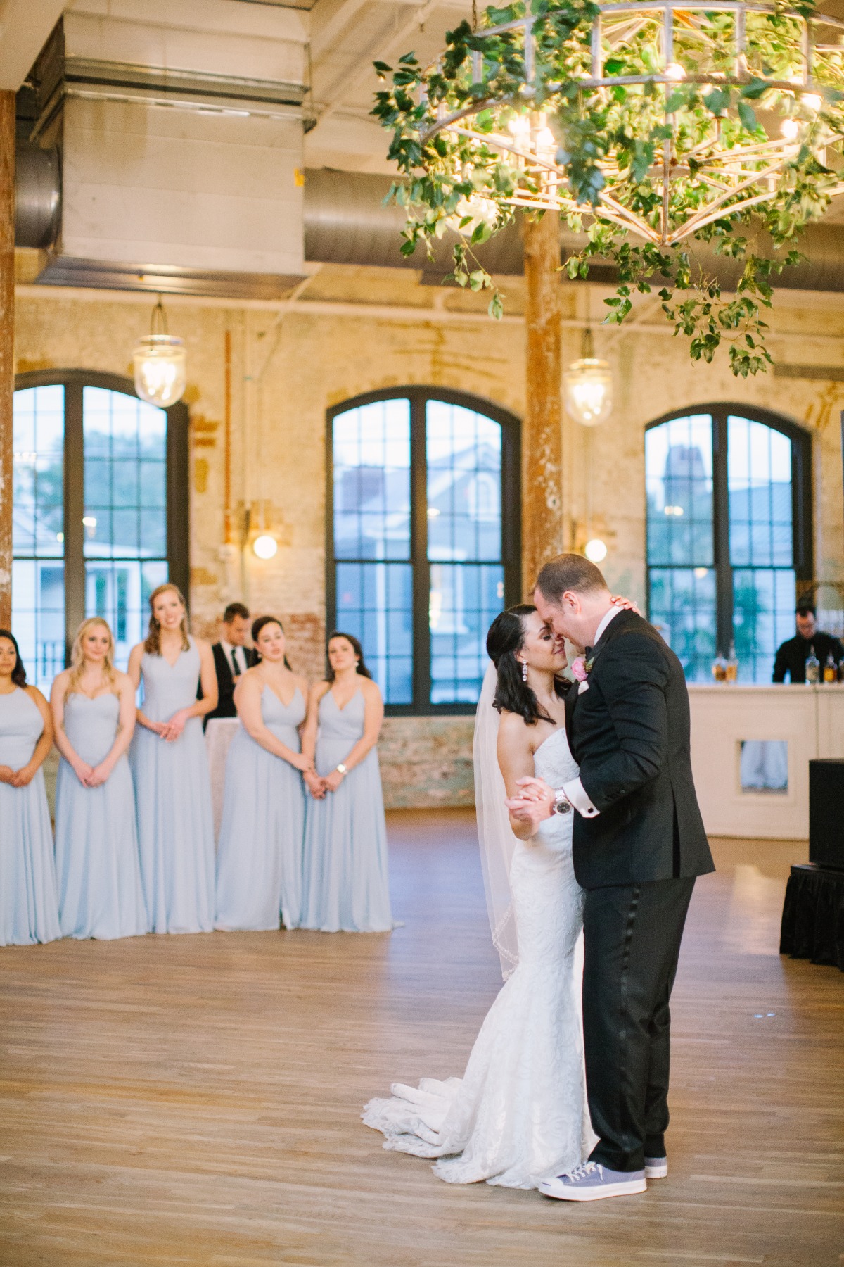 Bride and groom sharing a kiss during their first dance at wedding
