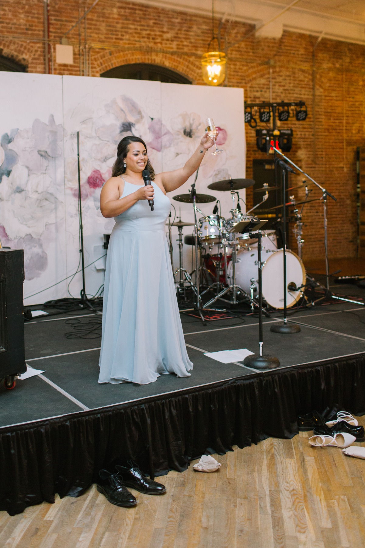 Woman giving a wedding speech, raising a glass in a toast
