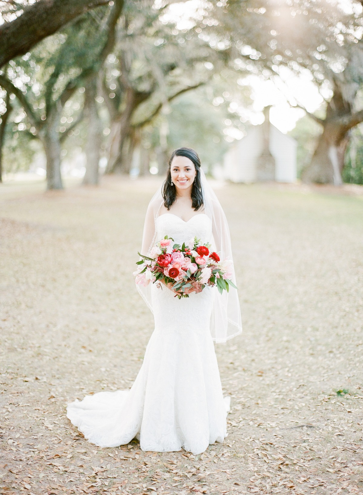 Beautiful bride in a white wedding dress holding flowers