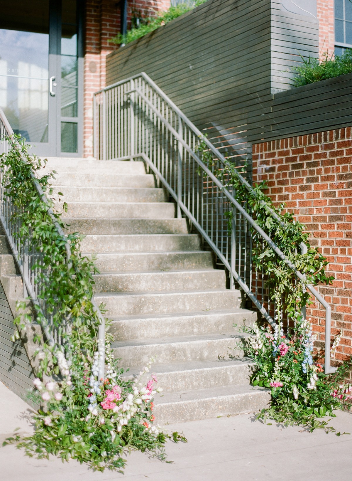 Concrete stairs with floral decorations leading to a doorway