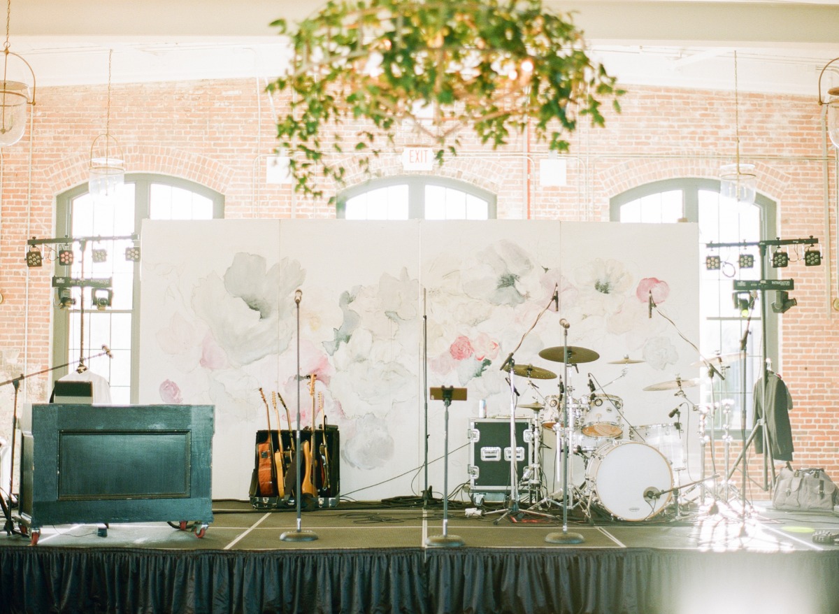 A stage set up with floral backdrop and band instruments