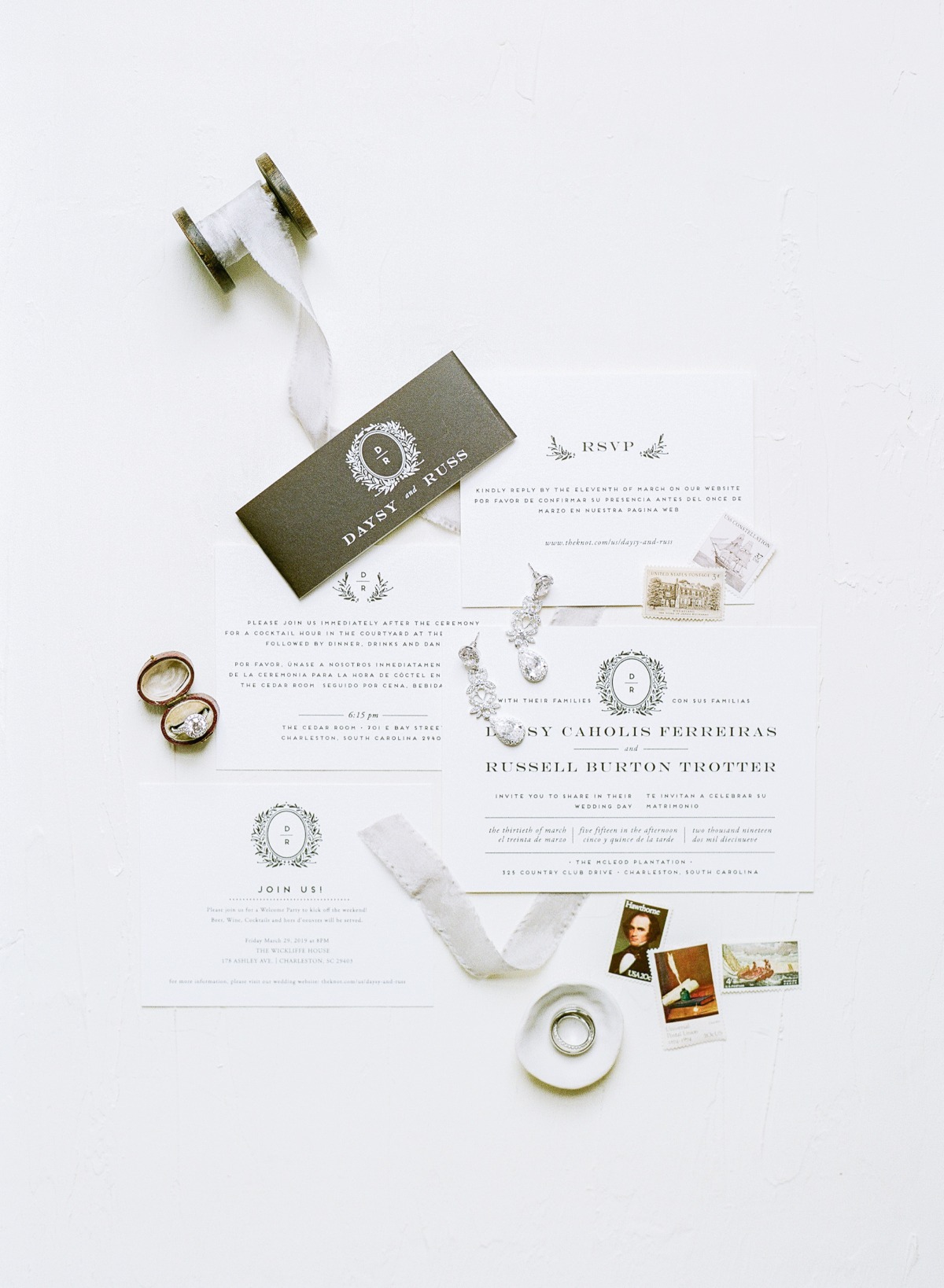 Elegant wedding invitation suite with rings and ribbon details