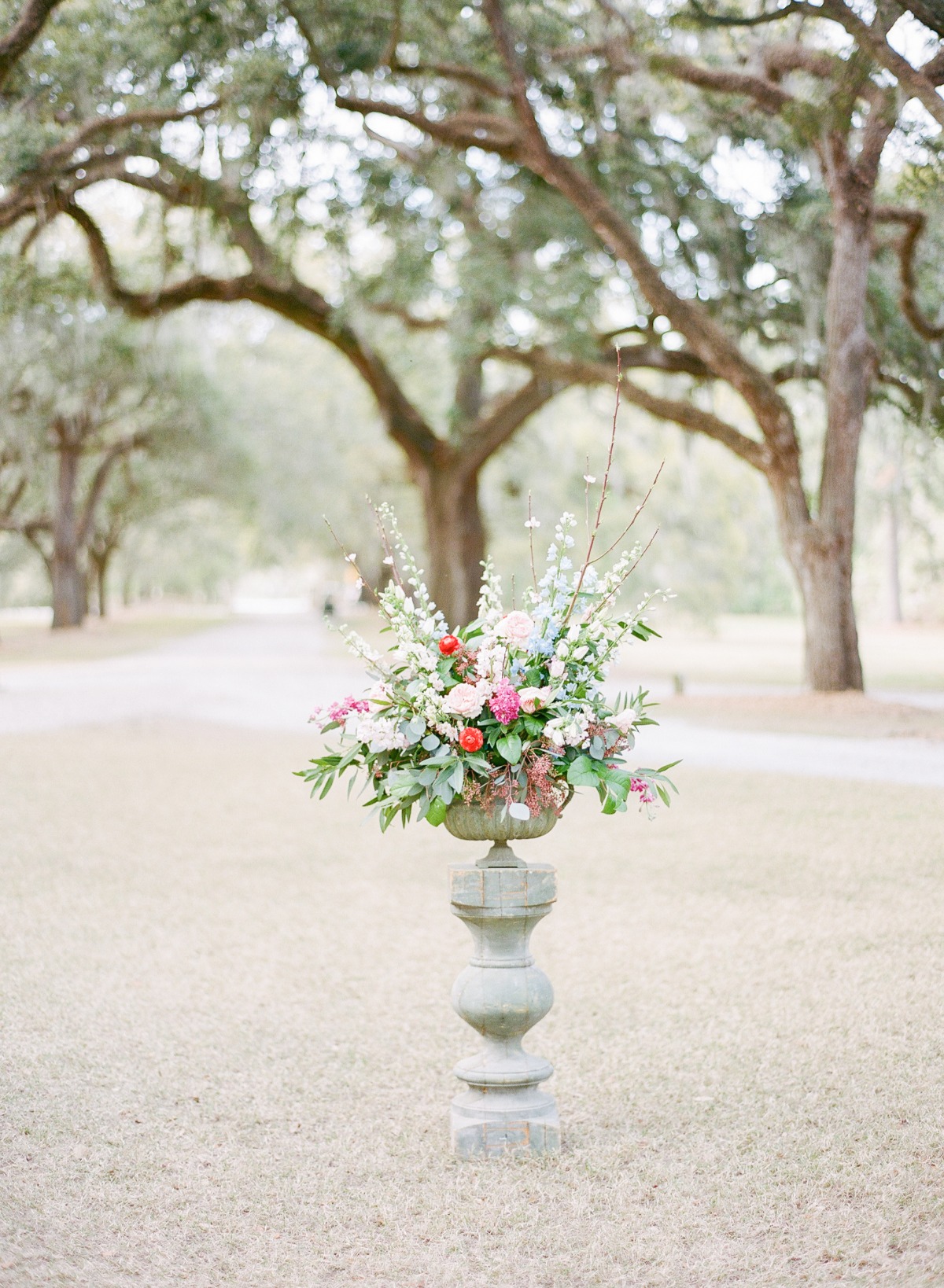 Floral arrangement in a vintage urn with a beautiful outdoor background