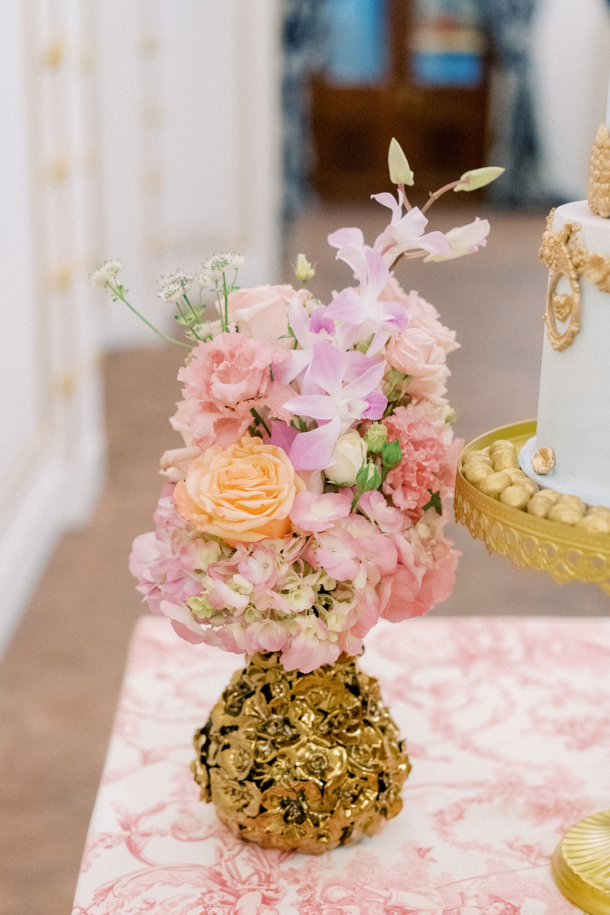 gold vase with floral arrangement
