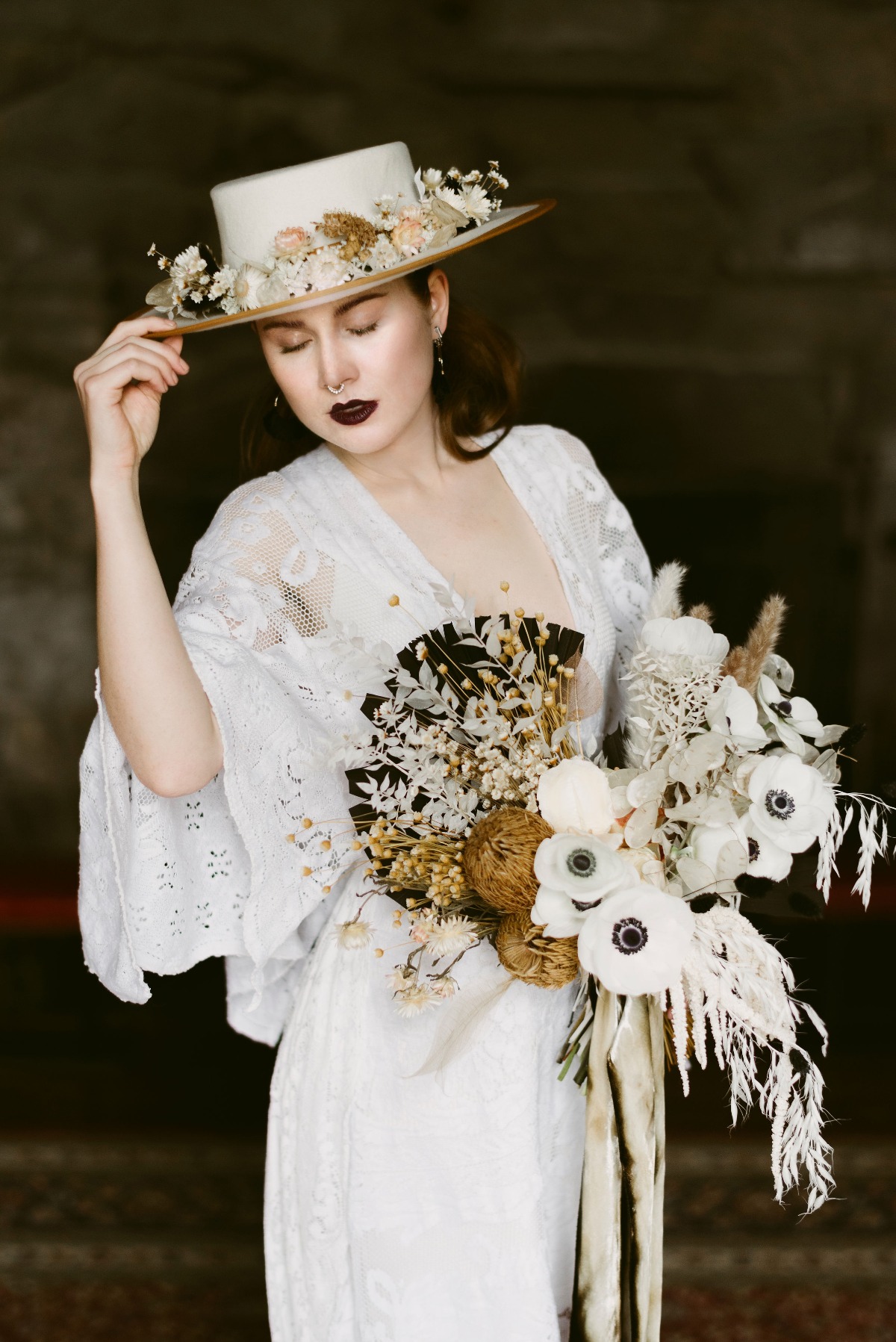 boho wedding dress paired with hat with dried florals