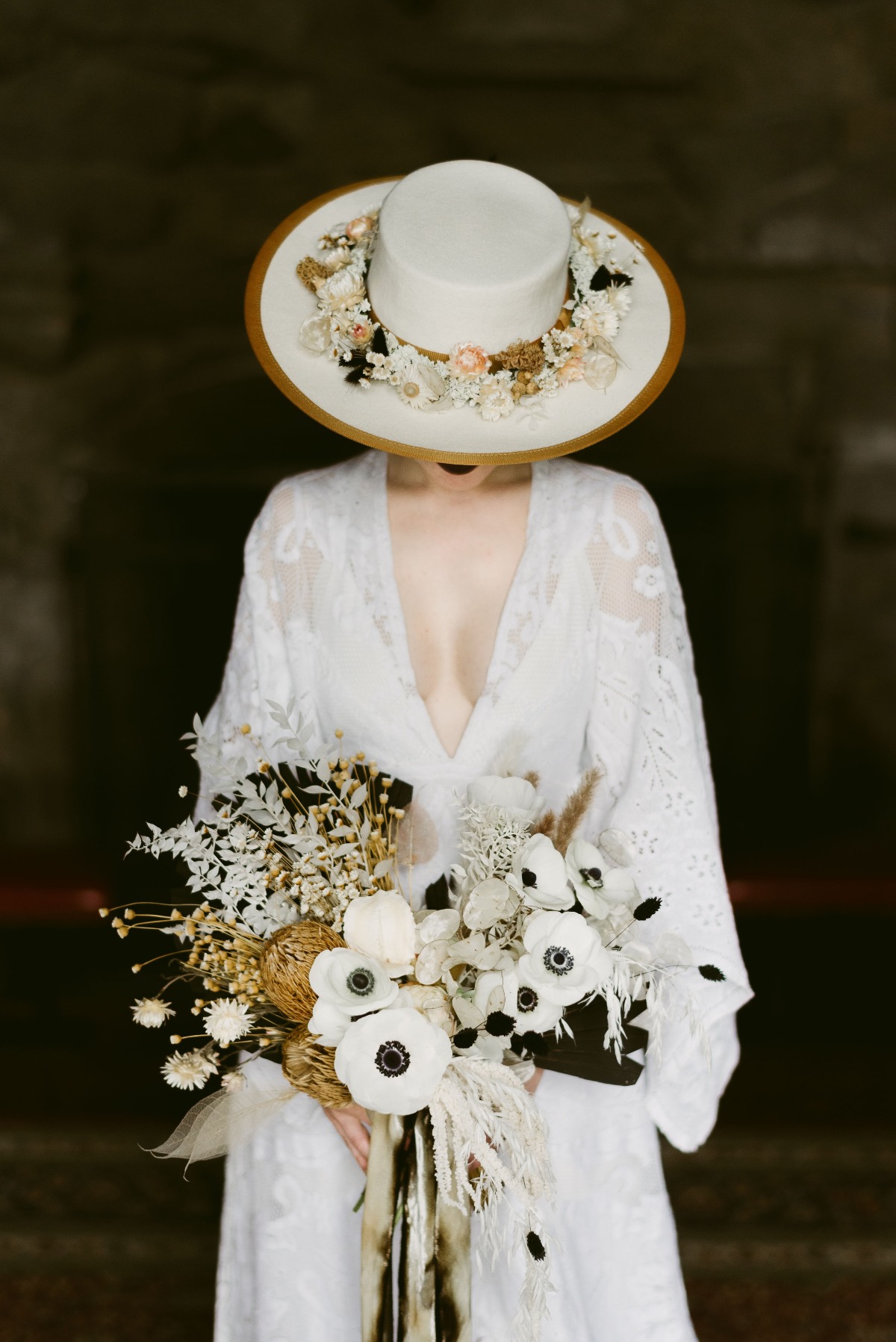 boho wedding dress paired with hat with dried florals