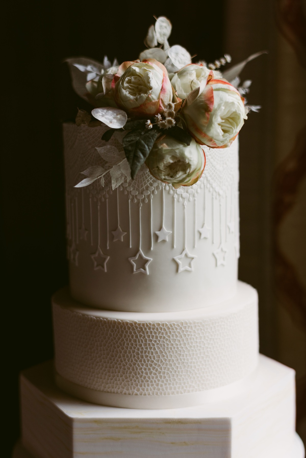 white wedding cake with stars and texture by The Fancy Cake Box