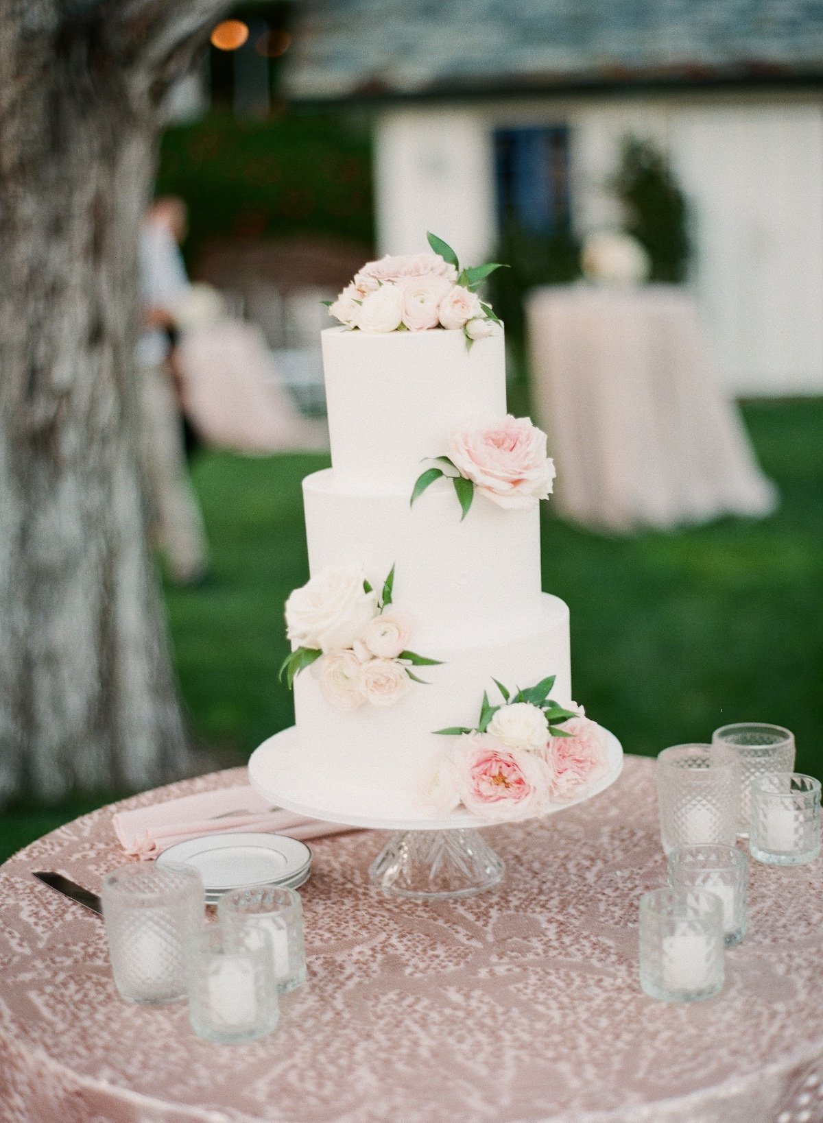 white wedding cake adorned with pink flowers
