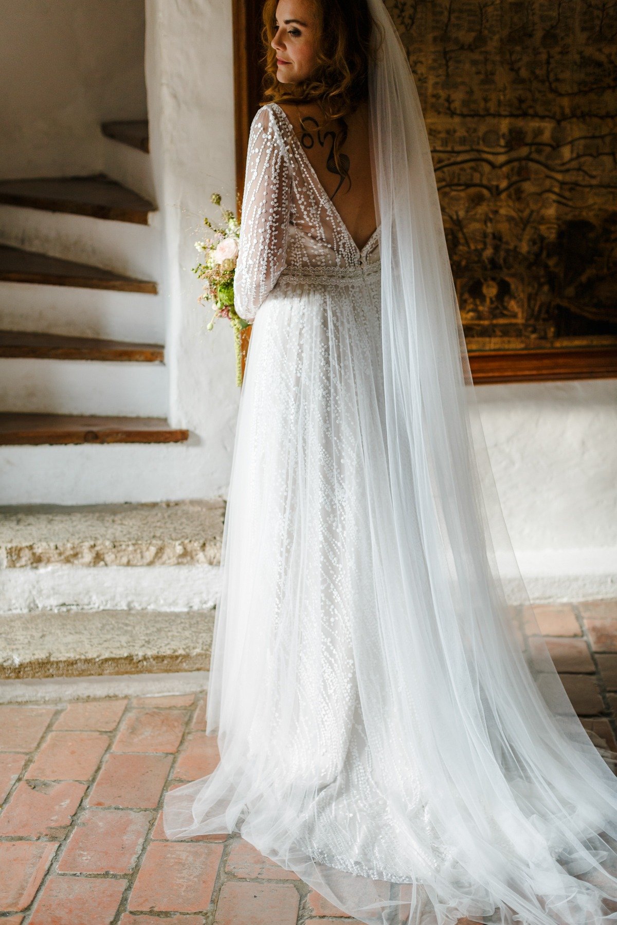 long sleeve wedding dress paired with long veil
