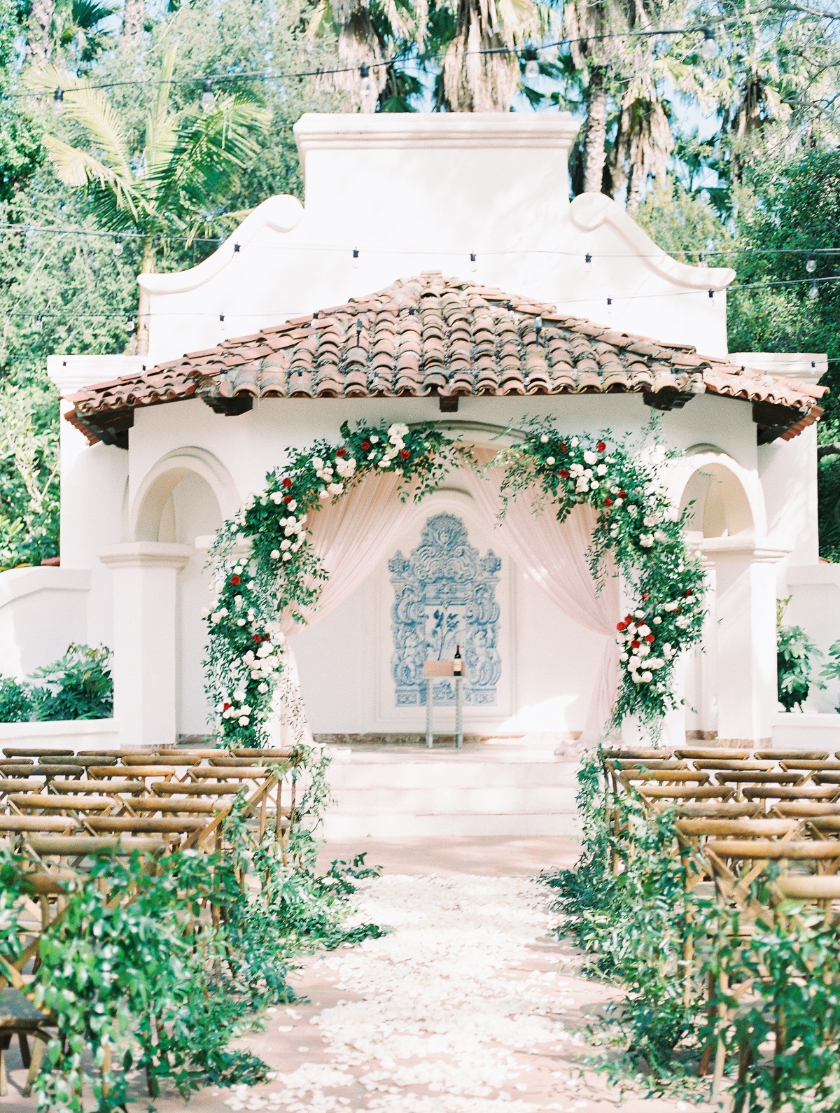 Outdoor wedding venue with floral arch and seating