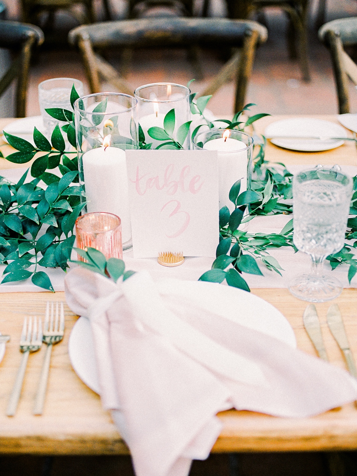 Elegant wedding table setting with greenery and candles