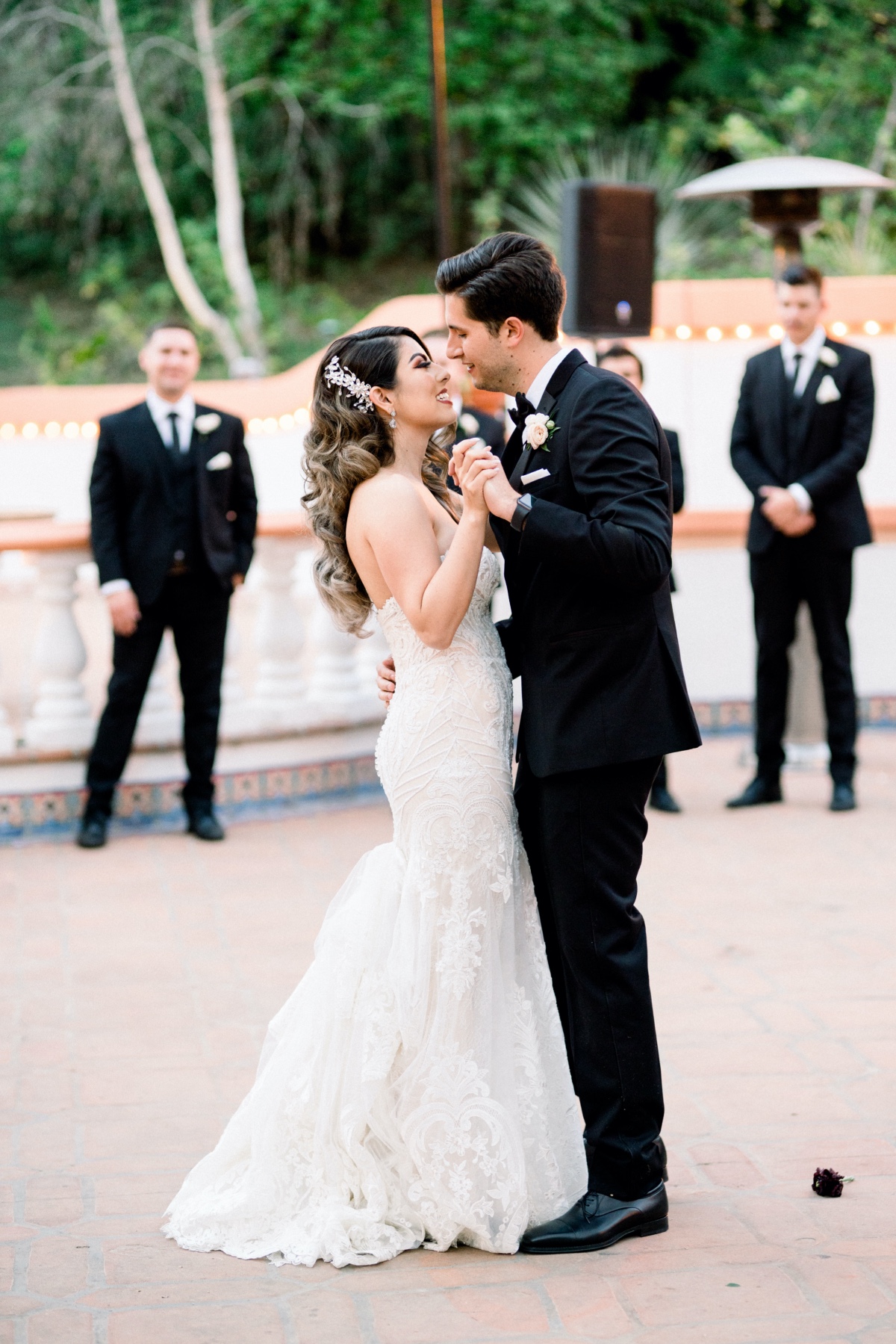 Bride and groom share first dance at outdoor wedding