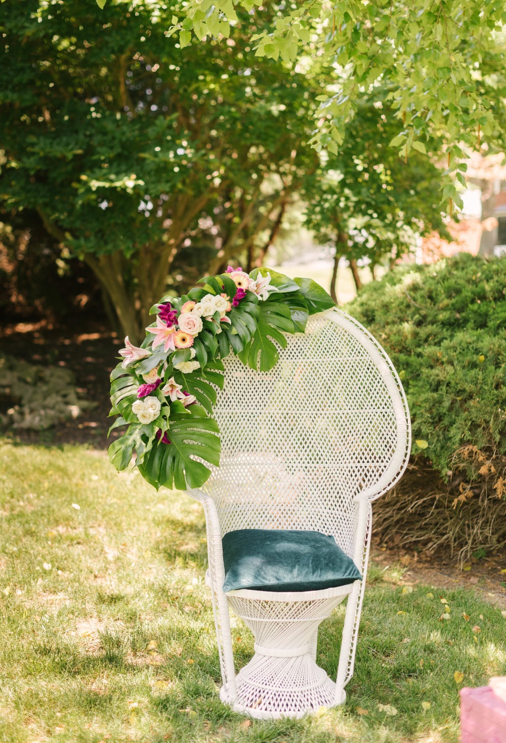 white peacock chair decorated with florals